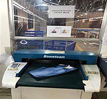 Jeans passing through a metal detection machine